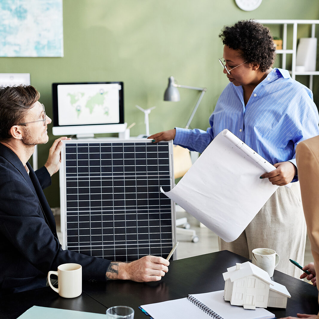 Group Of Engineers Working With Solar Panel In Team, They Discus POWER ASSESSMENT